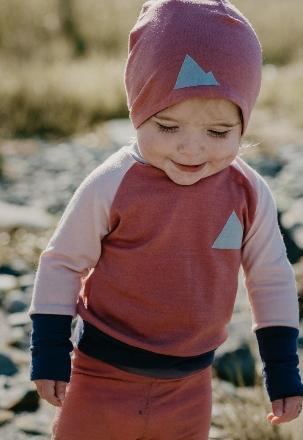 Baby in merino wool beanie hat and Crew Neck Top Base Layers Wildhaven Wools