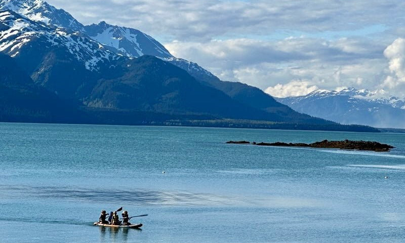 Ocean shoreline with mountains in the distance