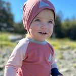 Baby in pink Merino Wool Beanie Hat and kids crew neck merino wool top made in the Alaska by Wildhaven Wools