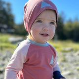 Baby in pink Merino Wool Beanie Hat and kids crew neck merino wool top made in the Alaska by Wildhaven Wools
