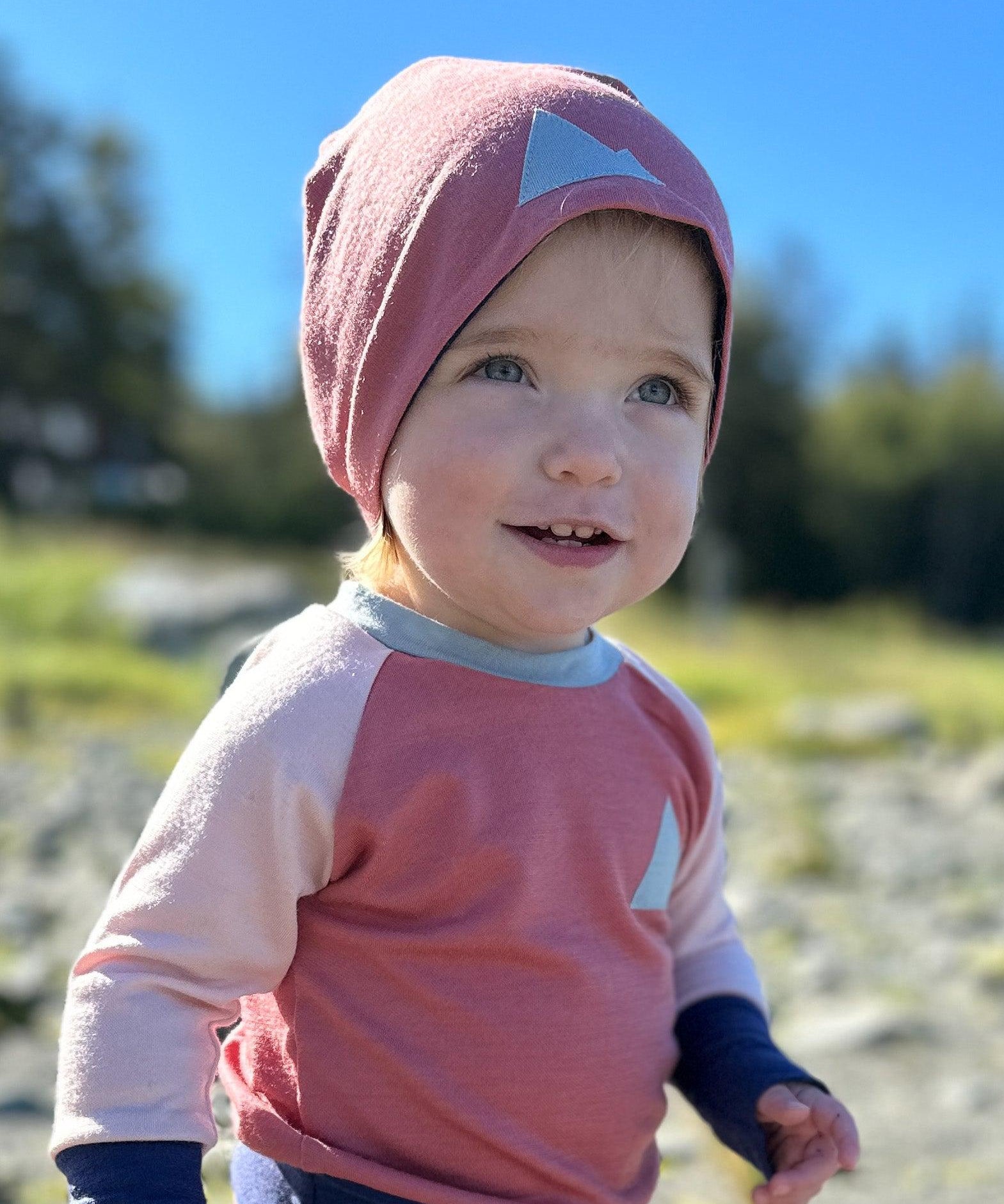 Baby in pink Merino Wool Beanie Hat and kids crew neck merino wool top made in the Alaska by Wildhaven Wools